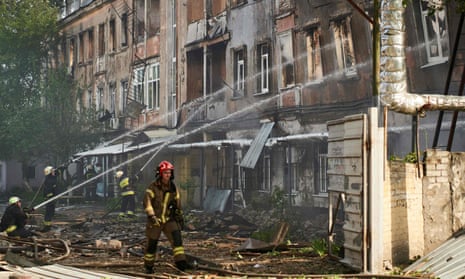 Firefighters at work at the medical facility destroyed in the Russian strike on Dnipro