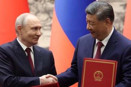 Vladimir Putin shakes the hand of Xi Jinping in Beijing, 20 May 2026.