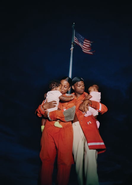 a men and women holding children