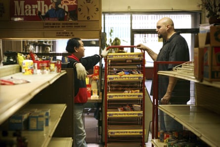 Two men speak inside a store