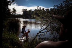 Luke Griffith’s daughters jump into the Murray river.