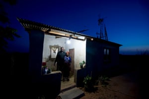 A family in Wimbe, central Malawi, on a remote farm powered by a series of windmills and solar panels