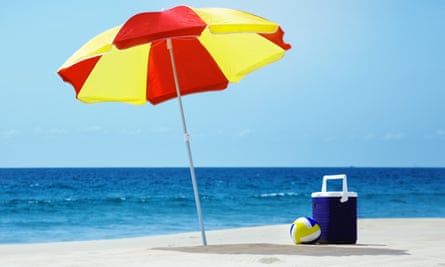 Empty beach with umbrella and accessories
