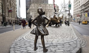 The Fearless Girl statue stares down the Charging Bull.