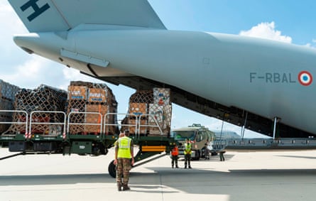French soldiers load a cargo plane at Istres military base with disaster relief bound for Libya on Wednesday.