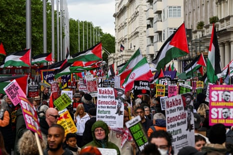 Protesters wave Palestinian flags.