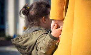 A child holds a woman's hand