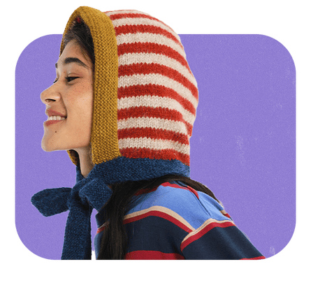 Female model wearing a knitted red-and-white bonnet.