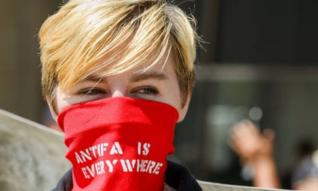 Stop the Hate Rally, Toronto, Canada - 11 Aug 2018Mandatory Credit: Photo by Shawn Goldberg/REX/Shutterstock (9788272ai) Woman wearing red bandana over face that reads “ANTIFA IS EVERYWHERE”. Stop the Hate Rally, Toronto, Canada - 11 Aug 2018
