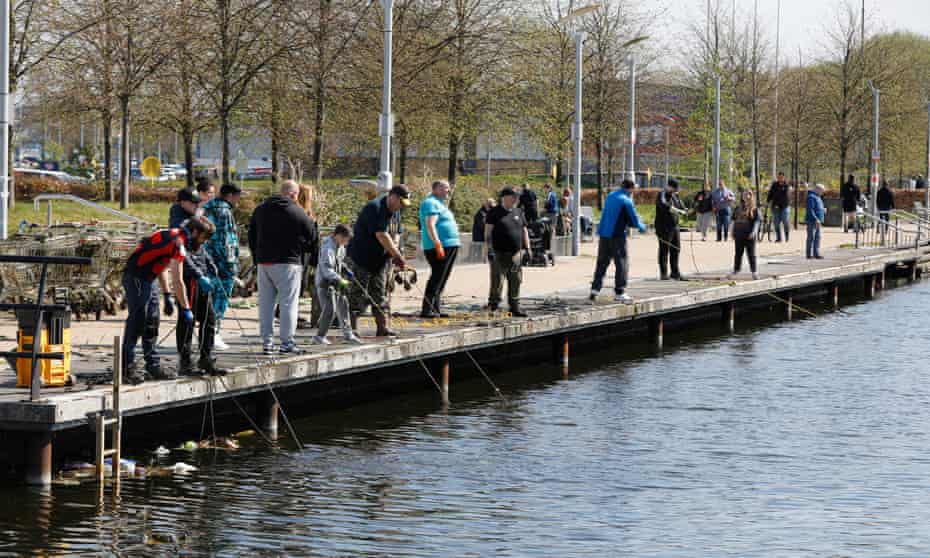 Members of the Glasgow Magnet Fishing group on a busy promenade