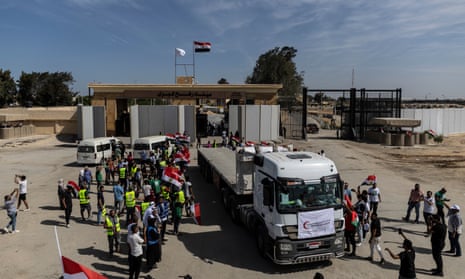 Volunteers and NGOs staff celebrate at the Rafah crossing after unloading supplies from aid trucks and returning to the Egyptian side of border on Saturday.