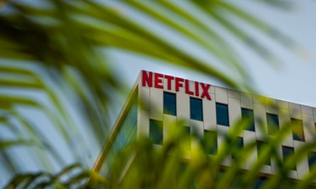 a building photographed through a palm tree with ‘netflix’ on the side