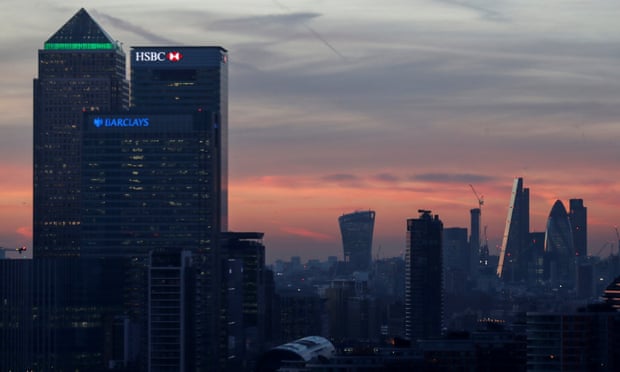 Canary Wharf and the City of London at sunset.