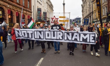 Protesters marching on London on Saturday with a sign saying ‘Not in our name’.