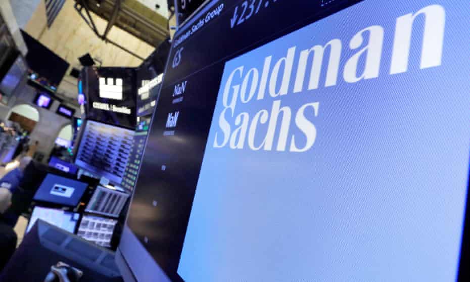 The logo for Goldman Sachs appears above a trading post on the floor of the New York Stock Exchange. 