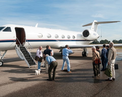 Passengers and dog preparing to board private jet for voyage to Uruguay