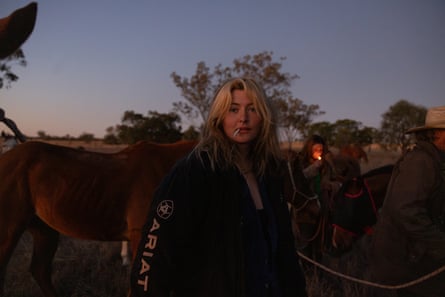 Kodee Judge, 17 collects the horses at sunrise ahead of a 12 hour day on horseback.
