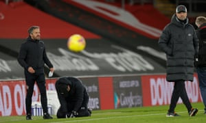 Ralph Hasenhüttl (second left) sinks to his knees in tears at the full-time whistle as Jürgen Klopp walks away.