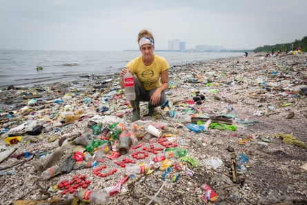 Greenpeace Canada Oceans campaigner Sarah King with a collection of Coca-Cola bottles and caps found on Freedom Island, Philippines