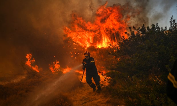 A firefighter battles to extinguish a fire in the village of Markati, near Athens, on August 16, 2021.