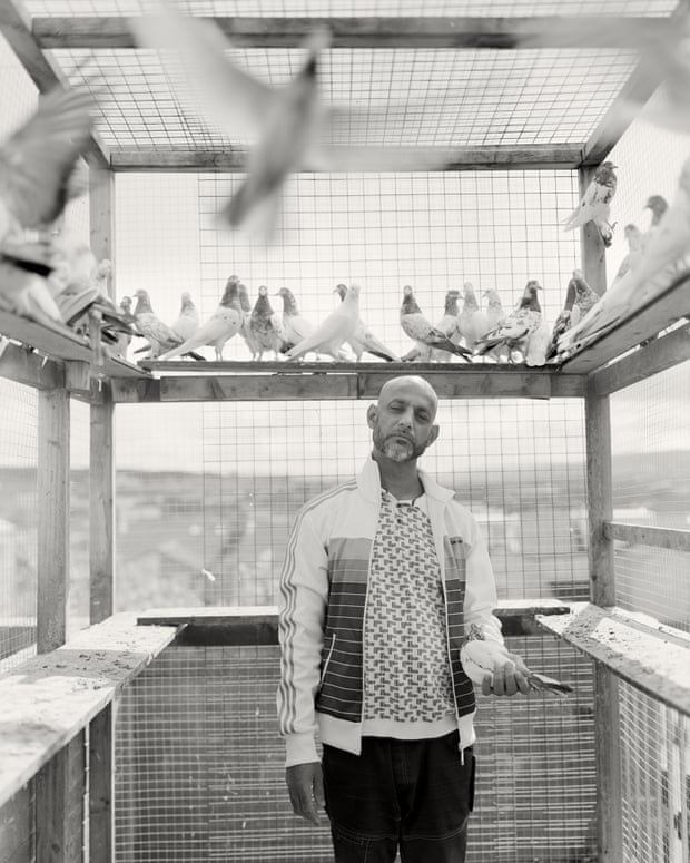 Mohammed Afzal with his pigeons in one of several cages he keeps on the tiny back terrace of his house in Johnson Street, Bank Top.