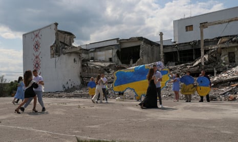 Lyceum graduates dance in front of the destroyed cultural centre in Derhachi, Kharkiv region 