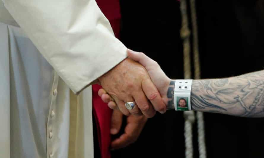 Pope Francis shakes hands with an inmate as he meets with prisoners at Curran-Fromhold Correctional Facility in Philadelphia, 27 September 2015.