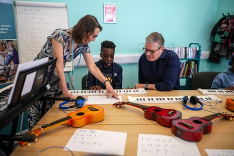 Keir Starmer talking to children and staff during a music lesson at Milton Keynes central library.