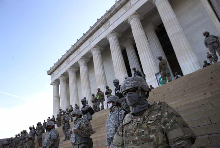 The DC national guard stand on the steps of the Lincoln Memorial as demonstrators participate in a peaceful protest.