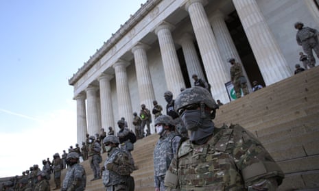 Members of the DC national guard stand on the steps of the Lincoln Memorial as demonstrators participate in a peaceful protest.