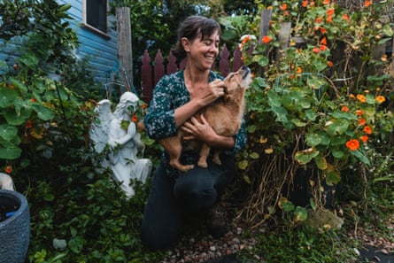 Jo Nemeth cuddling a pet dog in her garden