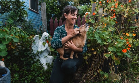 Jo Nemeth holding a dog in a garden