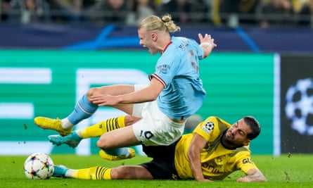 Erling Haaland is tackled by Emre Can