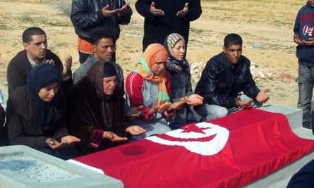 Relatives of Mohammed Bouazizi praying at his grave.