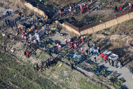 Rescue teams work amid the debris after a Ukrainian plane crashed near Imam Khomeini airport in Tehran