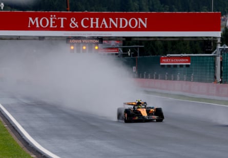 Lando Norris’s McLaren throws up a huge plume of water