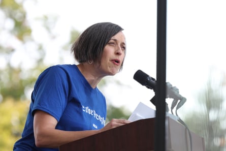 a women speaking in front of microphones