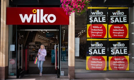 A woman walks out of a branch of Wilko