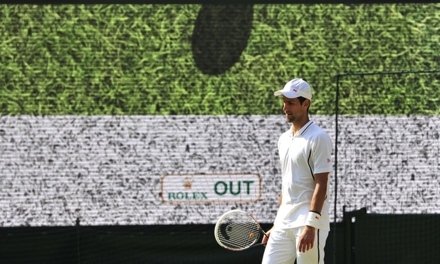 Novak Djokovic as the Hawk-Eye system rules a shot out at Wimbledon 2013.