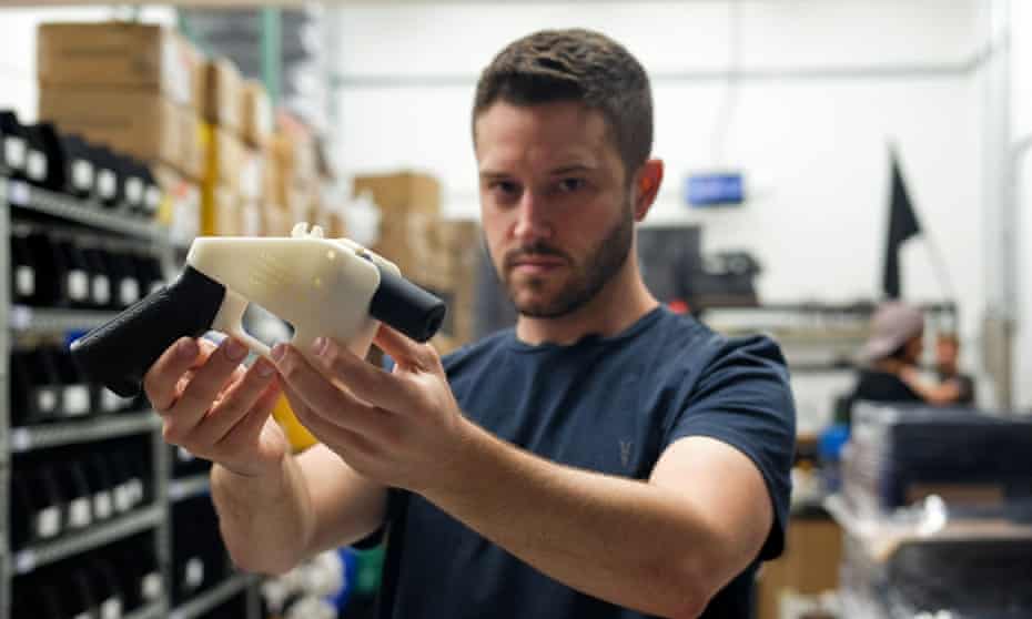 Cody Wilson, owner of Defense Distributed, holds a 3D-printed gun, was booked into Harris county jail in Houston.