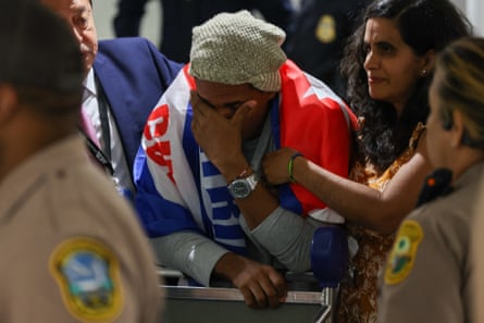 a man covering his face