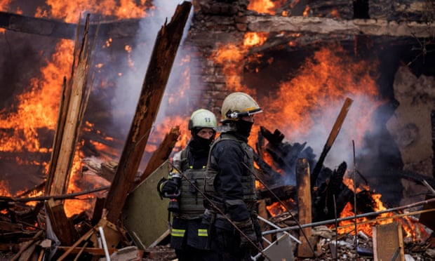 Firefighters work at a burning building, following a missile attack near Kharkiv International Airport