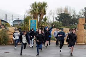 Young people run through gates