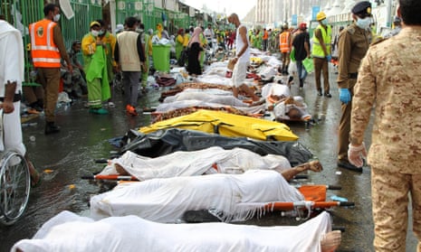 Saudi emergency personnel stand near bodies of hajj pilgrims