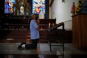 A Catholic worshipper prays during the Ash Wednesday service at the San Salvador Cathedral, in El Salvador