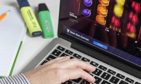 Person at a computer keyboard playing fruit machine slots