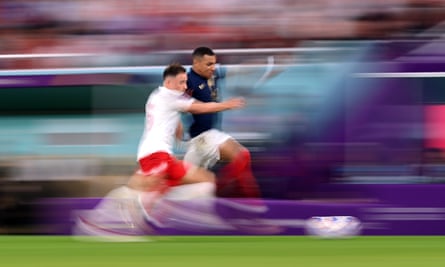 Kylian Mbappé runs at Poland's defence