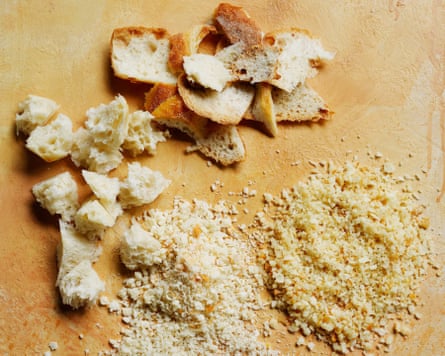 Breadcrumbs and bread on a benchtop