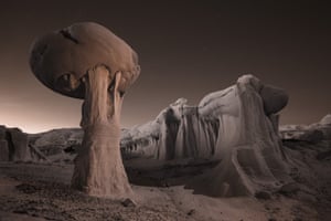 An infrared image at dusk of strange clay rock formations in Ah-Shi-Sle-Pah Wilderness in Farmington, New Mexico