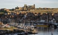 ruins of abbey in distance, harbour in foreground